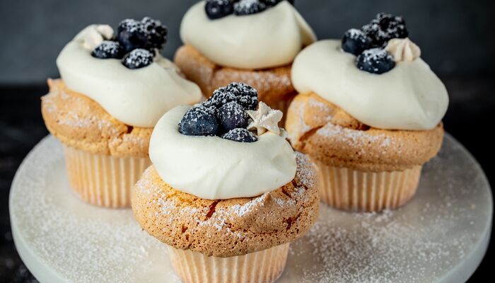 angel food cupcakes with whipped cream and berries made with Domino® Golden Sugar